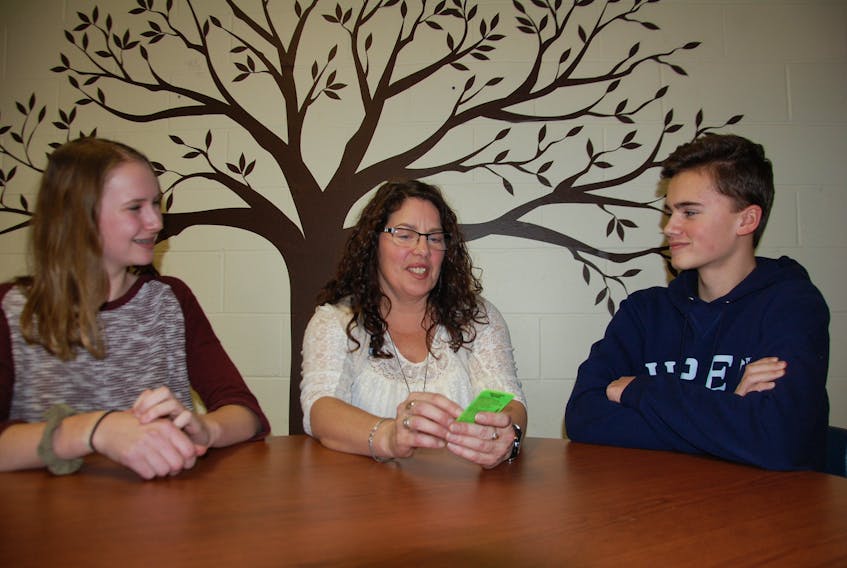 Pat Doyle, middle, suicide prevention co-ordinator with the P.E.I. division of the Canadian Mental Health Association, chats with East Wiltshire Intermediate School students Julie Goodwin and Simon Stretch. Doyle is in her 19th year of presenting a suicide prevention program to Grade 9 students in the province.