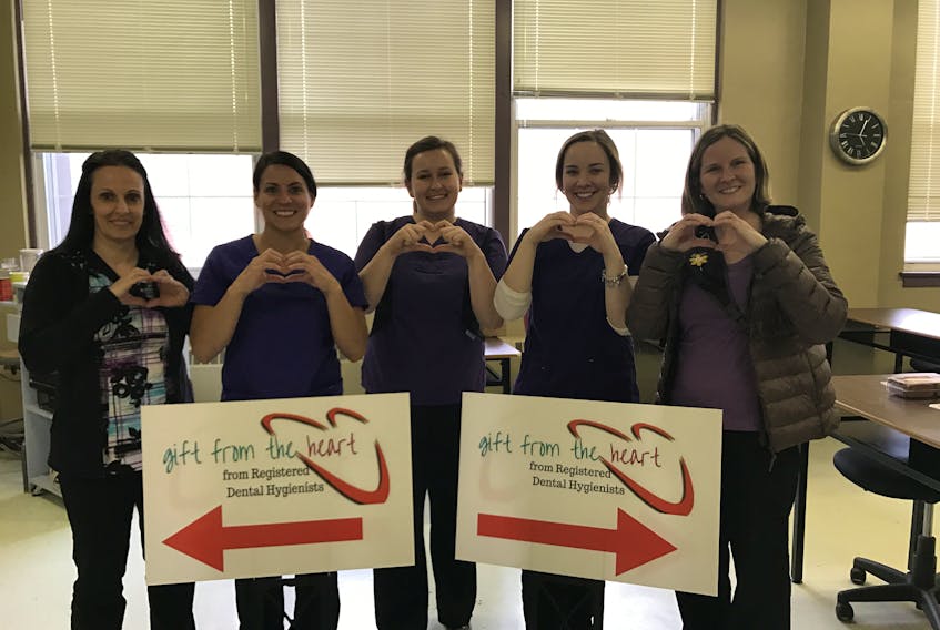 From left, P.E.I. dental professionals Tracy Bowser, April MacDougall, Katelin Stewart, Jess Hicken and Alison MacDougall prepare to provide free dental hygiene at a clinic April 7.