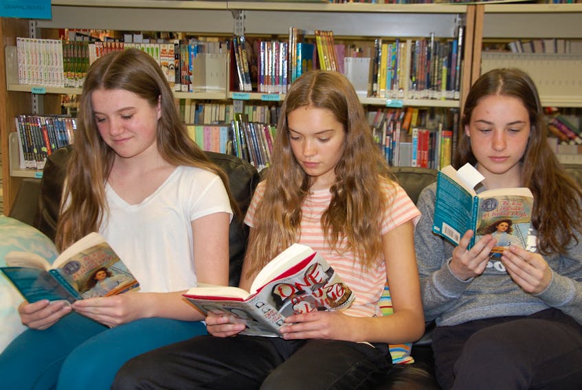 Grade 8 students of Queen Charlotte Intermediate in Charlottetown, from left to right, Kate Ford, Claire De Jong, and Olivia Devine participate in a literature circle in the school library. Results of the Pan-Canadian Assessment Program, which measures the performance of Grade 8 students, shows P.E.I. is one of five provinces at or above the Canadian average in reading.