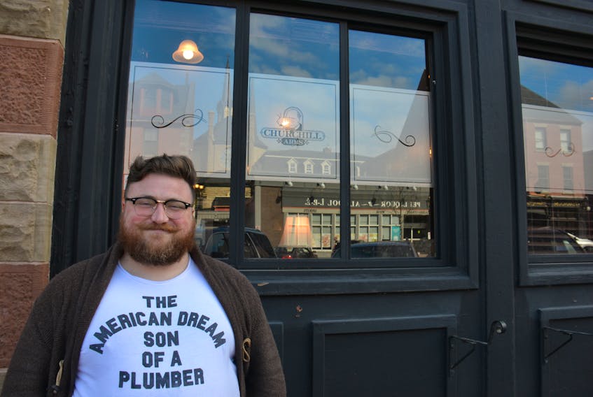 Local stand-up comedian Sam MacDonald is shown outside the Churchill Arms Pub where he hosts trivia Tuesday evenings.