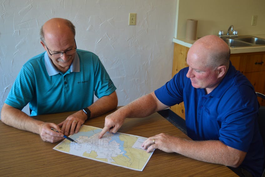 Coun. Terry Bernard, chairman of Charlottetown’s public works committee, and Mike Connolly, executive director of Cycling P.E.I., look over the new map created by the city and Cycling P.E.I. that shows every cycling route in the capital, as well as all the connectors. The city is currently soliciting feedback on the map from the public.