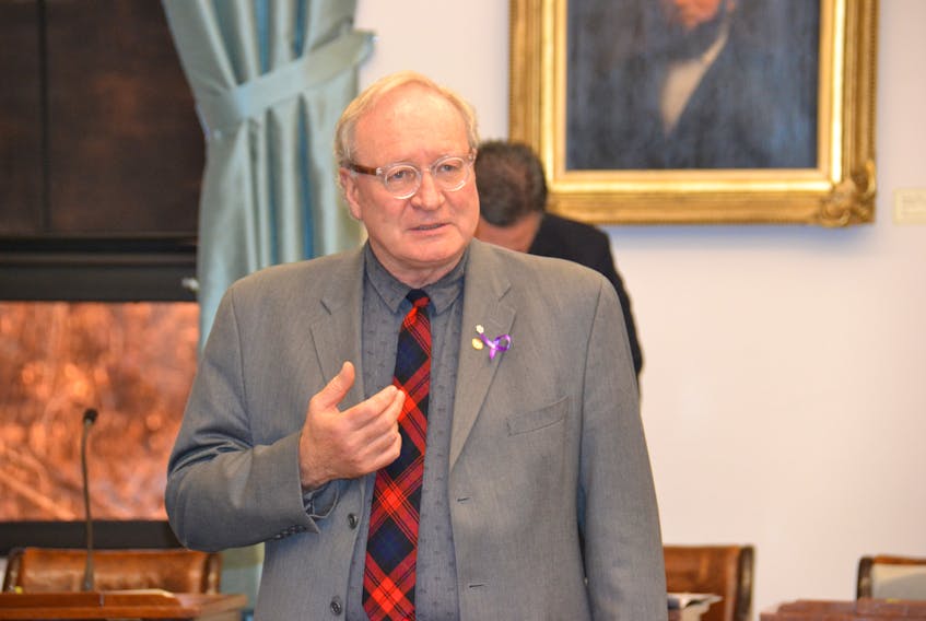 Premier Wade MacLauchlan, right, shown with Agriculture and Fisheries Minister Alan MccIsaac, did not provide new details on the impending carbon tax in the legislature on Friday.