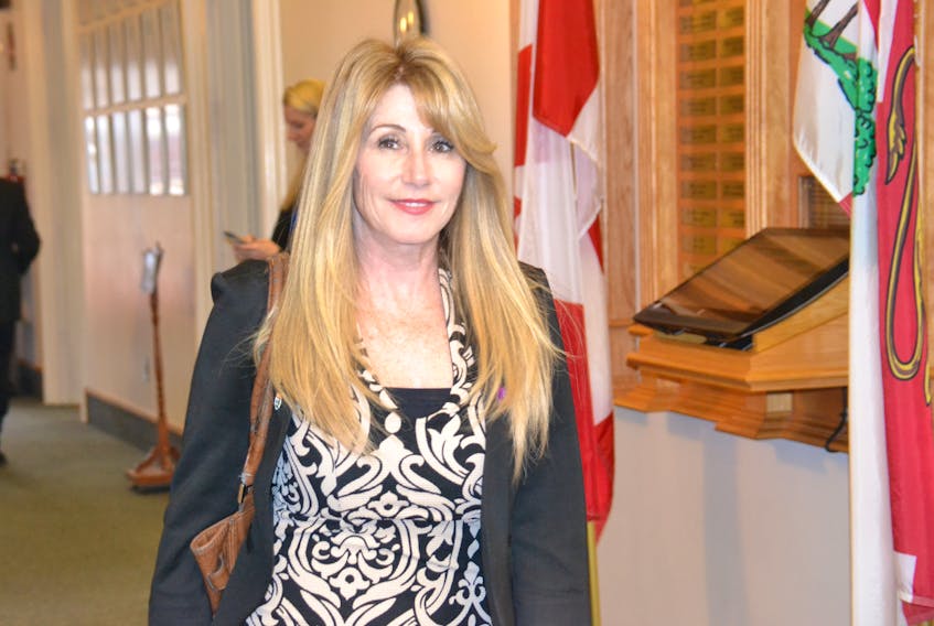 Tina Mundy, minister of family and human services, is shown entering the legislature on Thursday. During question period, she confirmed that 30 senior units are coming to Charlottetown.