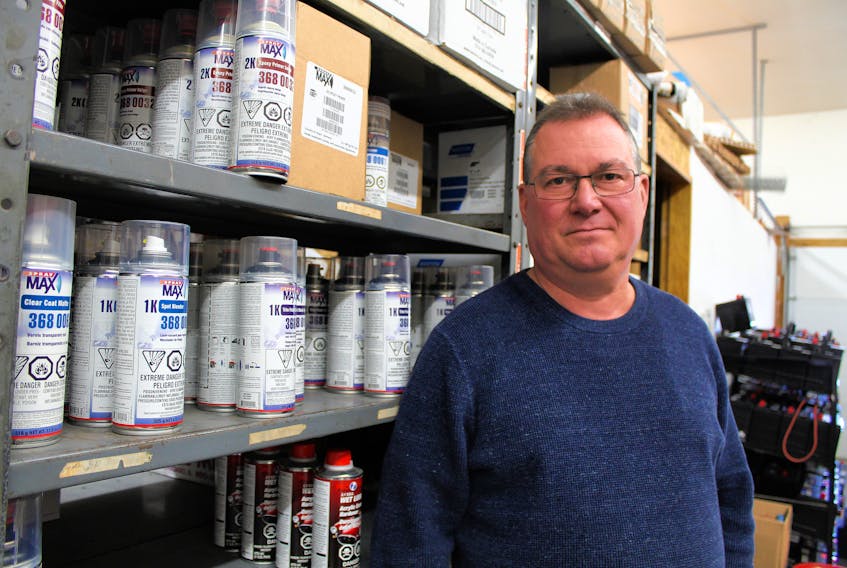 Eastern Auto Supply owner Thane Thomson stands next to shelves of paint at the Charlottetown business Friday after a former employee was sentenced to 60 days in jail for fraud, theft and forgery.
