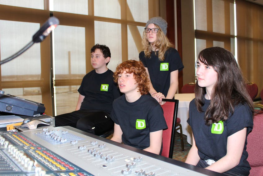 Teenage P.E.I. musicians, from left, Jesse MacCormac, Nicolas Dickieson, Vaughan Lloyd, and Casey Mann listen to a performance while learning how to run the soundboard backstage at the East Coast Music Awards on Saturday. The four young musicians, all members of the alt-rock band Moment of Eclipse, got to shadow the ECMA sound crew as part of the Backstage with TD program.