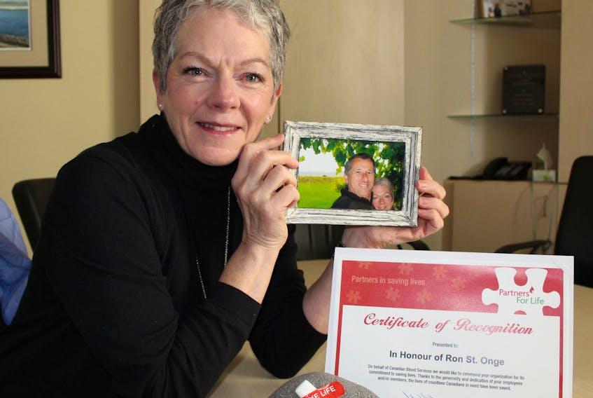 Wendy Toy holds a photo of her with her late husband Ron St. Onge who was an avid blood donor. Next to her is the bandage from her first time giving blood and a certificate from Canadian Blood Services for the blood clinic held each year in honour of St. Onge. This year’s clinic in memory of St. Onge is being held today.