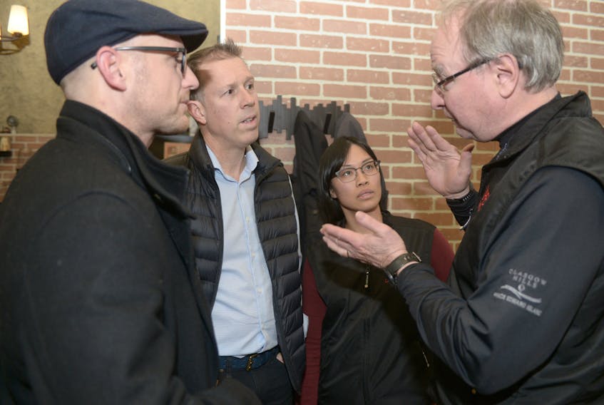 Don Jardine, project manager with UPEI’s Climate Research Lab, chats with senior research assistant Stephanie Arnold, Steve Arnold and Chris Buote, left, following a presentation at the Eagle Nest in North Rustico on Tuesday. Lab director Adam Fenech showed how sea levels that are rising quicker than anticipated will affect P.E.I., especially coastal communities.