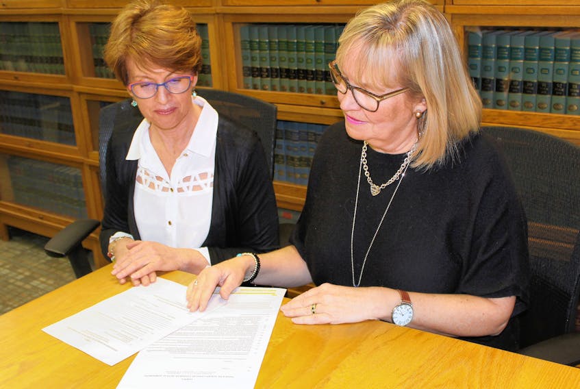 Island Regulatory and Appeals Commission (IRAC) senior communication officer Kim Devine, left, and Jennifer Perry, IRAC’s acting director of residential rental property review forms at the Commission’s Charlottetown office.