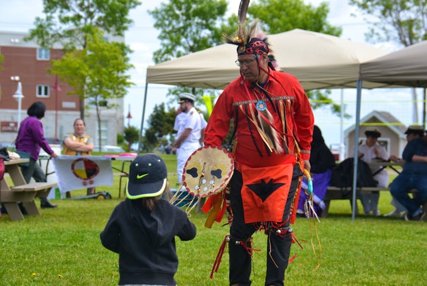 A child watches as Mike Julian dances in the traditional Mi’kmaq style. Both were attending the National Indigenous Peoples Day at Confederation Landing Park in Charlottetown on June 24.