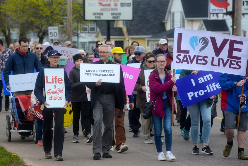 A group of pro-life demonstrators walks down St. Peters Road in Charlottetown during Sunday’s March for Life event. More than 100 people attended the march, which ended with a rally in front of the Coles Building.