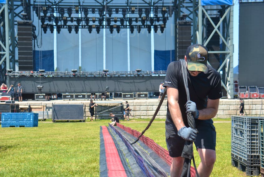 Kyle Gallagher sets up for the Cavendish Beach Music Festival on July 4.