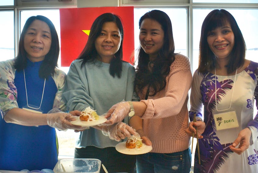 Uyen Nguyen, from left, Nga Do, Nga Pham and Doris Vuong serve some Vietnamese sticky rice, which is called gac, during Holland College’s Embracing Diversity Fair held at the Culinary Centre Thursday. The dish has a meaning of bringing good luck and is served on special occasions in Vietnam.