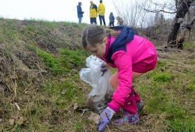 Seven-year-old Elizabeth Gormley picks up some trash along the Confederation Trail during a cleanup hosted by the City of Charlottetown on Saturday. The event saw many do their part to clean the trail of debris in Charlottetown, while many other Islanders helped tidy up their own communities Saturday as part of the P.E.I. Women’s Institute’s annual roadside cleanup Saturday.