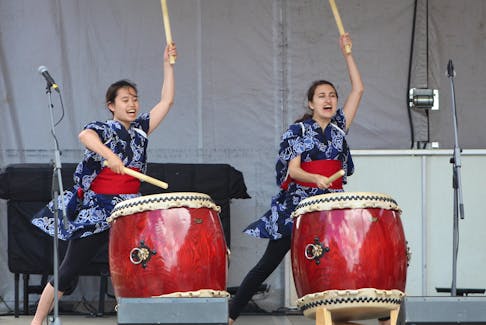 Madoka Imamuta, left, and Brianna Comeau filled the air with the boom of their traditional Japanese drumming for the 13th DiverseCity Multicultural Festival on Sunday with their Japanese drum group Saint Mary’s University Taiko.