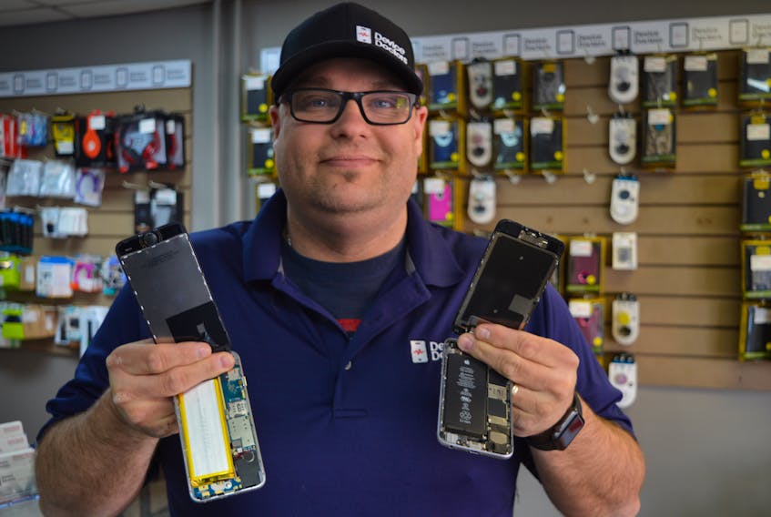 Cory Rusk, owner/operator of Device Doctors in Charlottetown, says they’ve seen a lot of fake iPhones lately and wants to issue a warning to the public. The fake phones are virtually identical to the real thing. One of the only ways to tell is to take the phone apart. He’s holding a fake phone in his left hand and a real one in his right hand.