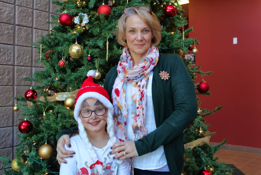 Nancy Fullarton and her eight-year-old daughter, Sophie, celebrate during the P.E.I. Military Family Resource Centre’s Christmas party at the Murchison Centre Sunday. The party was a chance for military members, veterans, RCMP and their families to share in some festive joy.