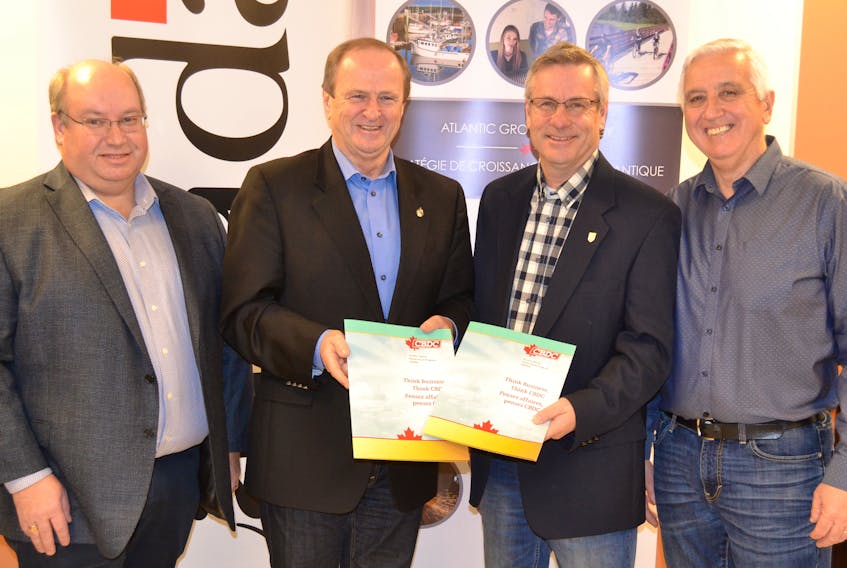 Kevin MacLeod, left, chairman of the board of directors of CBDC West Prince Ventures; Egmont MP Bobby Morrissey; P.E.I. Fisheries Minister Robert Henderson and Rural and Regional Development Minister Pat Murphy review the application process for the 2018-19 Quality Oyster Aquaculture Program.