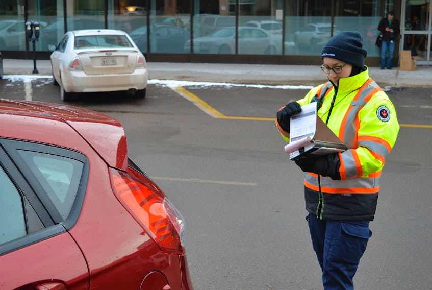 Parking commissionaires in Charlottetown, like Alexie Mireault, will soon be issuing parking tickets using electronic ITAP Mobile devices. The devices will also allow commissionaires and police to instantly flag stolen vehicles and those associated in missing person cases.