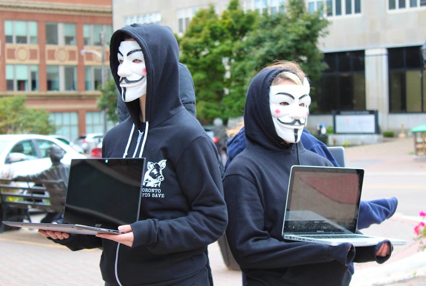 A local group of Anonymous for the Voiceless members don Guy Fawkes masks and form a “cube of truth” in Charlottetown Saturday as a demonstration against using animals for food or clothes. The group said it hopes the demonstration will be the first of many of its kind held in Charlottetown.