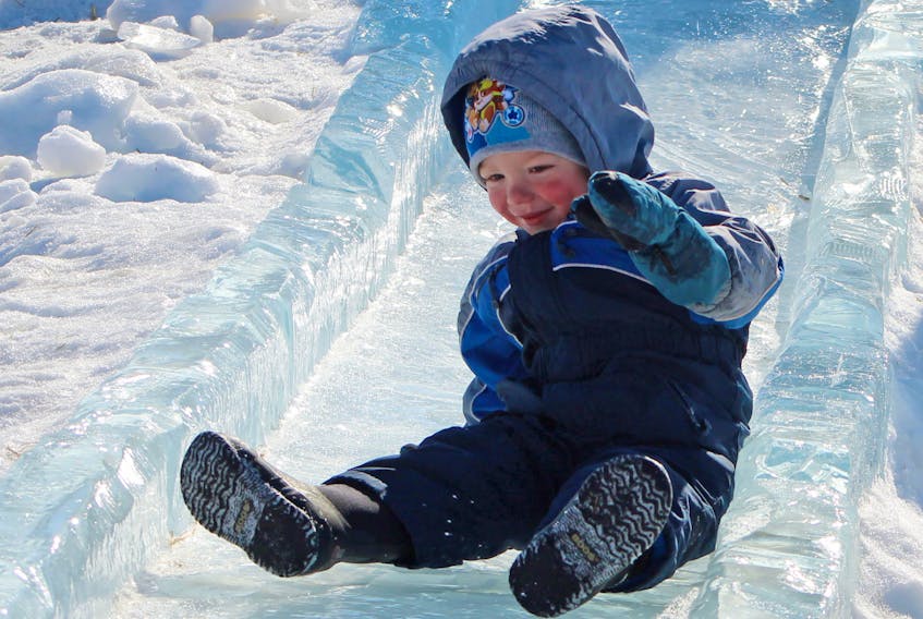 Two-year-old Gus Godfrey of Annapolis Valley enjoys going down the toddler ice slide during this year’s Jack Frost Winterfest.