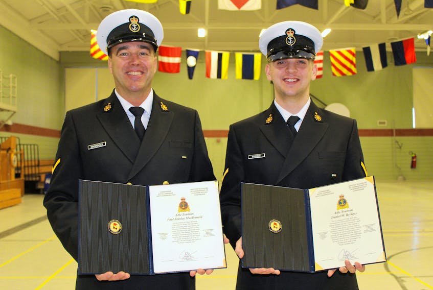 Able Seaman Paul MacDonald, left, and Able Seaman Daniel Bridges hold the Commander of the Royal Canadian Navy Command Commendation Award. The award, which is given to recognize deeds that go beyond the demands of normal duty, was presented to the two men Jan. 19 while other members were also recognized for their roles in rescuing 15 people from a sinking ship in the Charlottetown Harbour.