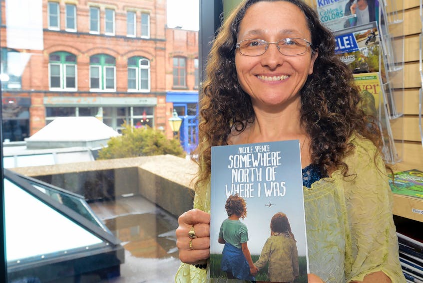 Author Nicole Spence holds a copy of her book, “Somewhere North of Where I Was”, published by Acorn Press, during a recent P.E.I. launch at the Confederation Centre Public Library. The book is a memoir of Spence’s childhood, which included abuse at the hands of a P.E.I. foster parent.