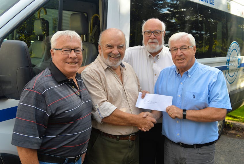 Bruce MacDougall, right, and Lee MacDougall, left, donated $5,000 to Pat and the Elephant on Monday in memory of their sister, Sharon, who died earlier this year. Sharon was a frequent user of the accessible transportation service. Accepting the cheque is Terry Davis, president of Pat and the Elephant, with Halbert Pratt, manager.