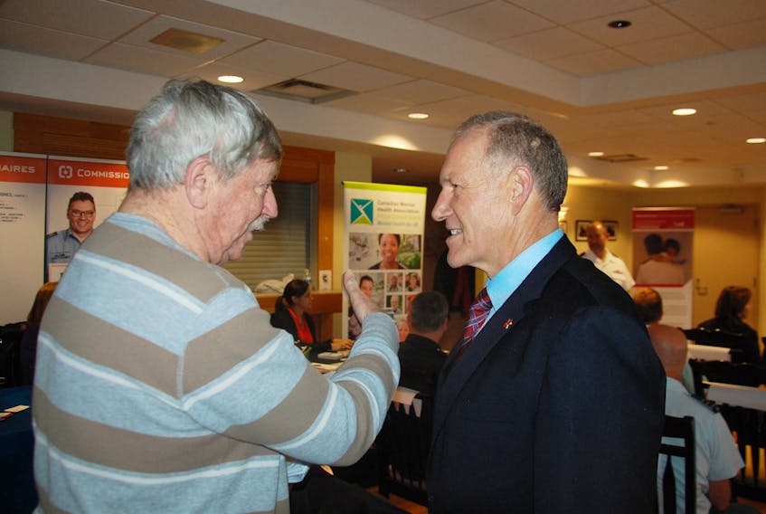 Veterans Affairs Deputy Minister Walt Natynczk, right, chats with Summerside veteran George Dalton, a strong advocate for the care and recognition of veterans, before speaking in Charlottetown Thursday during the official launch of the local branch of the Veteran Family Program.