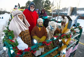 Ira Boyle, from left, Chrys Jenkins and Jacob Taylor spend some time with alpacas in the Canoe Cove living nativity scene entry in the recent Charlottetown Christmas parade. The nativity scene, which supports Santa’s Angels and the P.E.I. chapter of the Children’s Wish Foundation, will be open for viewing this Friday, Saturday and Sunday evening in Canoe Cove.