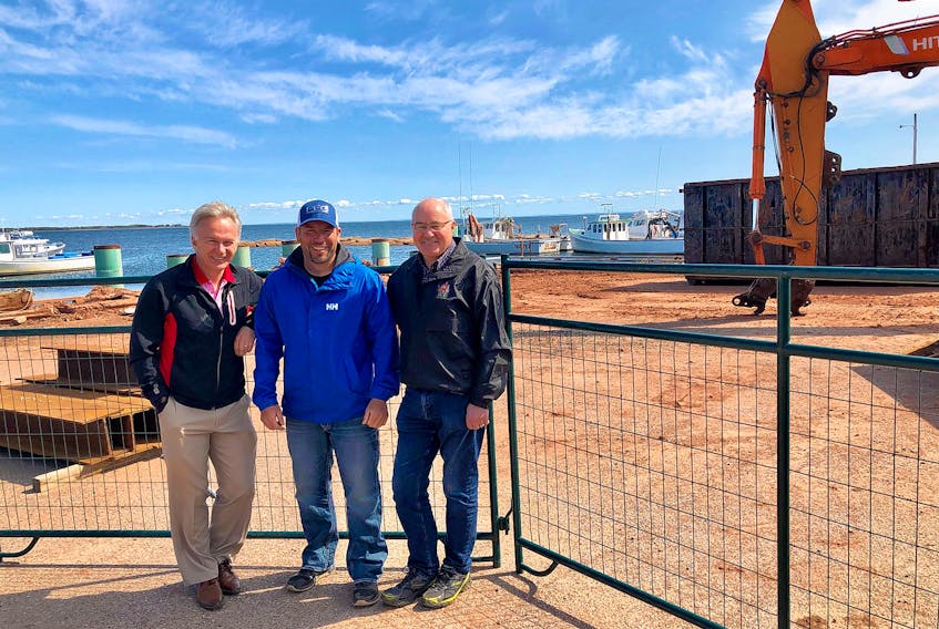 Charlottetown MP Sean Casey, left, along with Andrew Bryanton, president of the Nine Mile Creek Harbour Authority, and Malpeque MP Wayne Easter, right, pose for a photo after viewing the work being carried out at Nine Mile Creek Harbour. Construction currently underway to replace a portion of the wharf should be completed later this fall. As the harbour is currently at capacity, the work will expand the number of boats used for the commercial fisheries as well as for aquaculture. Nine Mile Creek Harbour has a dozen lobster boats and an equal number of boats for aquaculture operations such as mussels and oysters.