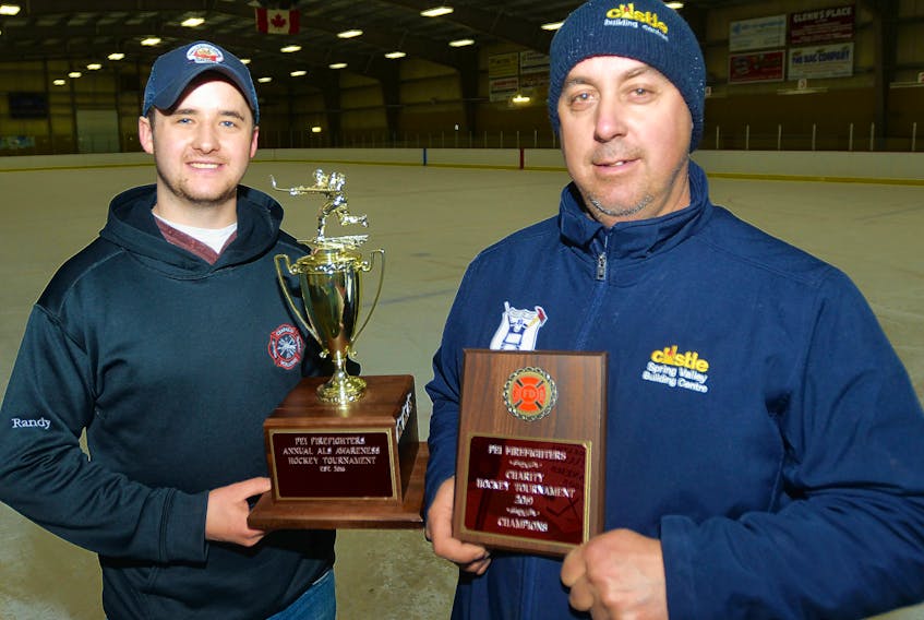 Crapaud fire chief Chris Paynter, right, and firefighter Randy Shaw show the trophy and plaque for the volunteer department’s annual hockey tournament in support of the ALS Society of P.E.I. The host fire department won the tournament this year, which has raised about $21,000 over its four years. The department’s member will be back to fundraising this Friday with a benefit planned for David Walsh, whose ALS diagnosis several years ago led to the creation of the tournament.