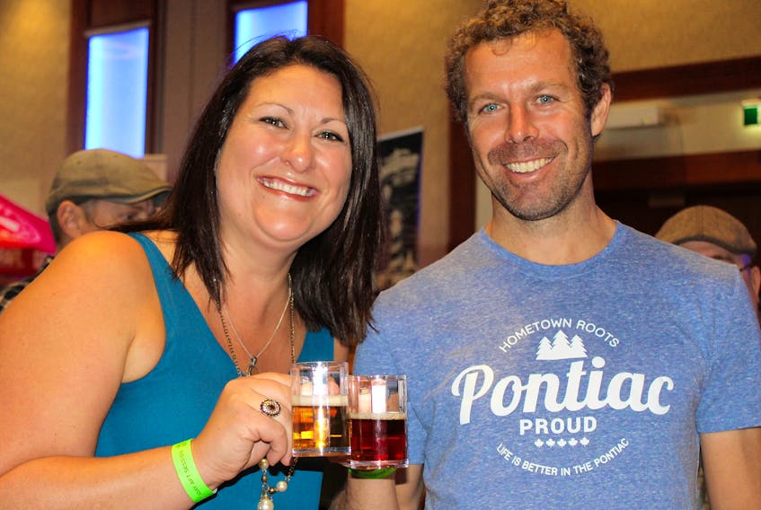 Jenna Connolly, left, and Matt Twiddy enjoy some brew from Warfarers’ Ale Craft Brewery while at the 2018 P.E.I. Beer Festival held in Charlottetown on the weekend.