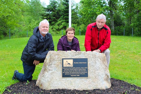 Paul Jenkins, Shirley Prowse and Robert Bryenton are shown at the new granite and bronze monument commemorating the first buildings to be erected in the Brackley area in the 1800s. Missing from the photo is Alta Acorn.