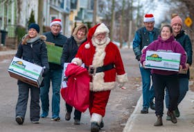 Santa and some of his angels carry boxes of goodies and a big bag of presents to a Charlottetown on Christmas Day. The organization gave out more than 500 boxes of food and presents and also visited the Queen Elizabeth Hospital, Prince Edward Home and Beach Grove Home along with other seniors’ homes and care facilities. From left, is Crystal Demeulenaere, Roy MacArthur, Lynn MacArthur, Tommy Corrigan, Lawrence Corrigan, Hanna Dykerman and Anika Dykerman.