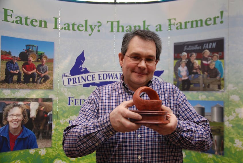 Darren Peters, of Somerset Farms in Maple Plains, holds up the 2019 Gilbert R. Clements Award for Excellence in Environmental Farm Planning. His farm was recognized with the award Friday at the P.E.I. Federation of Agriculture’s annual meeting.