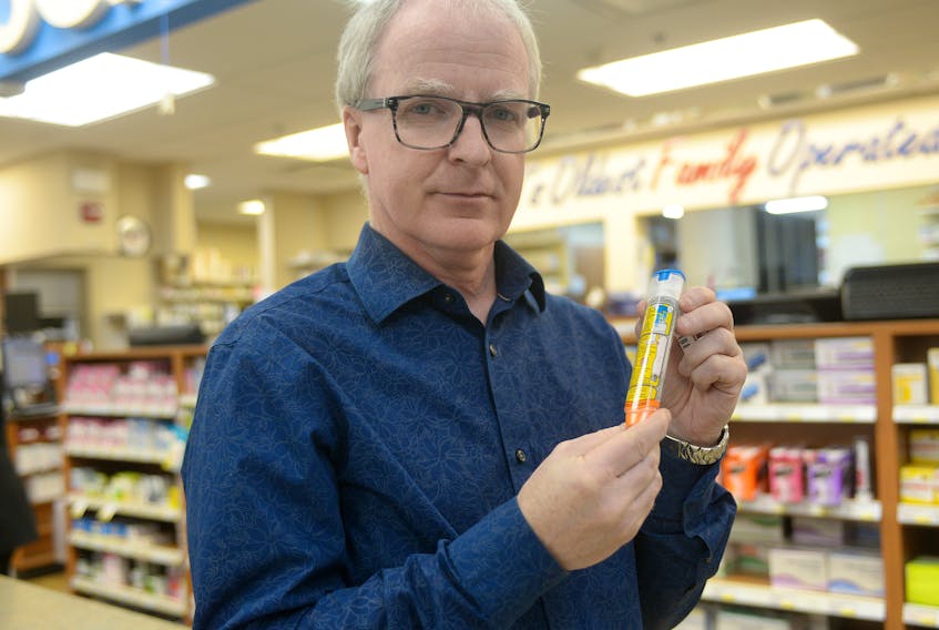 Pharmacist Rob MacLellan holds up an EpiPen at the Sherwood Drug Mart in Charlottetown. Pharmacists in P.E.I. are monitoring a shortage of EpiPen auto-injectors in the 0.3 milligram format.