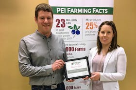 Kyle Maynard of Farmboys Inc. is presented with the 2019 Food and Farming Champion Award from Santina Beaton, Farm and Food Care P.E.I. co-ordinator, at the Murchinson Centre in Charlottetown earlier this month.