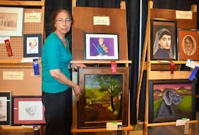 Farida Chishti displays a painting that is part of display for the P.E.I. Women’s Institute handcrafts, horticulture and arts show at the 2018 Old Home Week exhibition in Charlottetown.