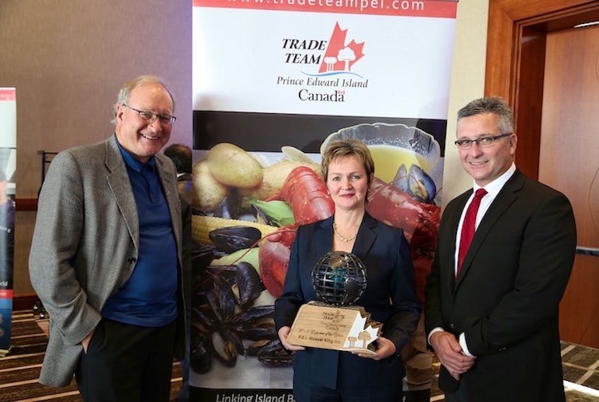 P.E.I. Mussel King was the recipient of the 2015 Trade Team P.E.I. Exporter of the Year Award, presented by Premier Wade MacLauchlan, left. Esther Dockendorff, president of P.E.I. Mussel King, accepted the award on behalf of the company. Also in photo is former Economic Development Minister Heath MacDonald.

(IIS Photo)