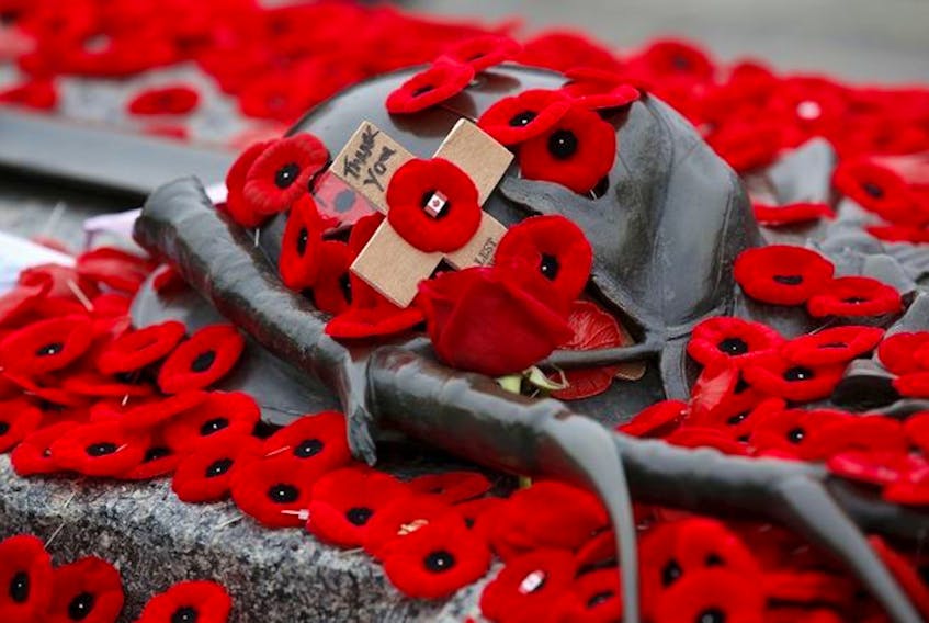 Poppies cover headstone during Remembrance Day ceremonies
(Legion Magazine)