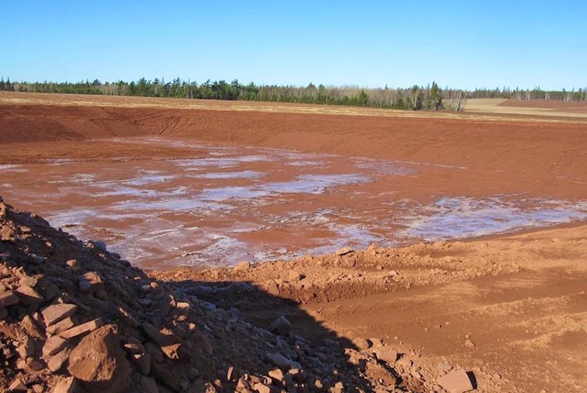 A new irrigation pond recently dug in Spring Valley area will be used to irrigate nearby potato fields.
(Dale Small photo)