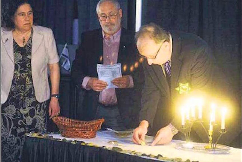 The annual Holocaust Memorial service in Charlottetown remembers six million murdered Jews during the Second World War. From left, Rosalie Simeone, Leo Mednick of the Jewish Community of P. E. I. and Kim Dormaar.