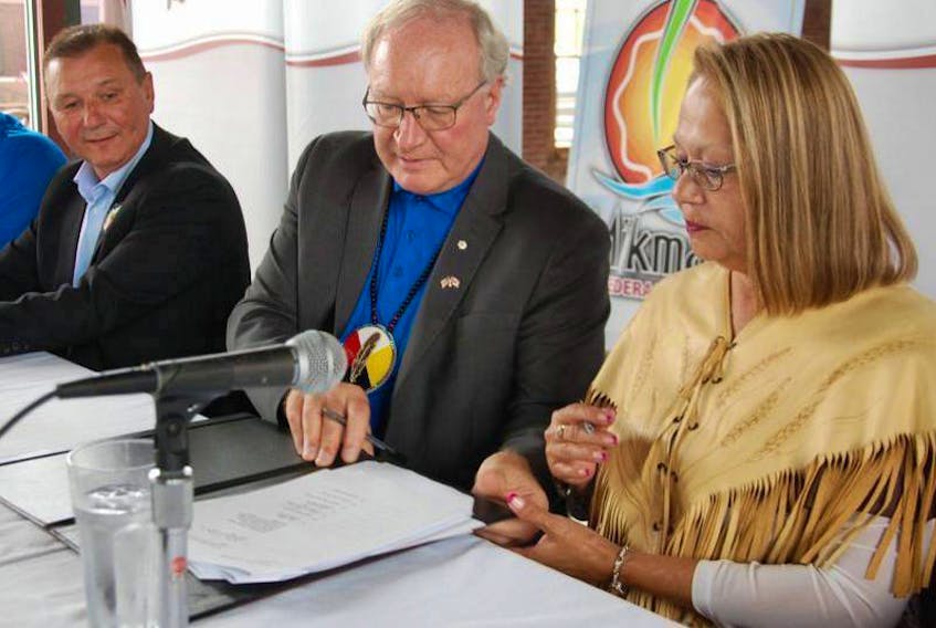 Premier Wade MacLauchlan, centre, is joined by Chief Brian Francis of the Abegweit First Nation and Chief Matilda Ramjattan of Lennox Island First Nation on August 30, 2017, in signing a development agreement between the government of P.E.I. and Island Mi’kmaq.

 (The Guardian / File Photo)