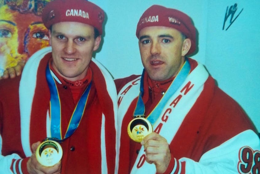 Dave MacEachern of Charlottetown, right, and teammate Pierre Lueders, display their Olympic gold medals won in two-man bobsled event 20 years ago this week in Nagano, Japan.
(Submitted photo)