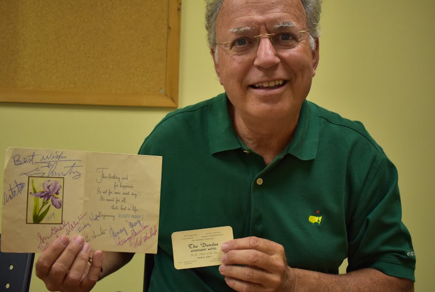 John McMillan holds a birthday card presented to the late Loretta Perry, the manager of Dundee Apartment Motel, from Louis Armstrong in 1958, along with Perry’s business card.