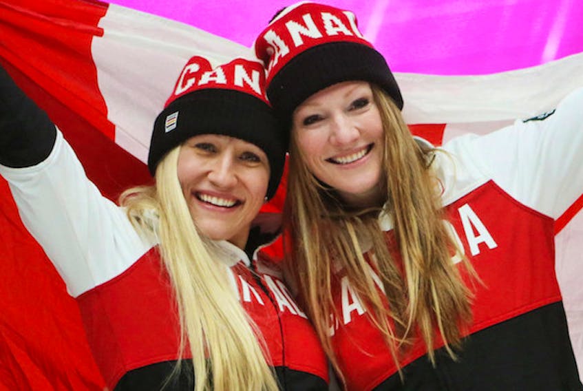 Kaillie Humphries, left, and Heather Moyse of Canada celebrate after the fourth run of the Women's bobsled competition at the Sanki Sliding Center at the Sochi 2014 Olympic Games, Krasnaya Polyana, Russia, February 19, 2014. 
PHOTO: EPA/Fredrik von Erichsen