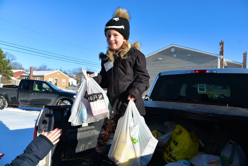 Volunteer Juliet Trainor, 7, was part of a crew that picked up and delivered donations to the Upper Room Food Bank during Sunday’s 28th annual Stratford and Area Food Drive. In addition to the food items, the drive also saw about $1,400 donated for items.
