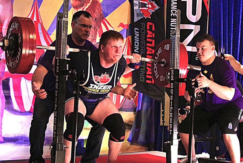 Jacob Sinnott performs a squat lift at the national powerlifting championships earlier this year in Quebec.