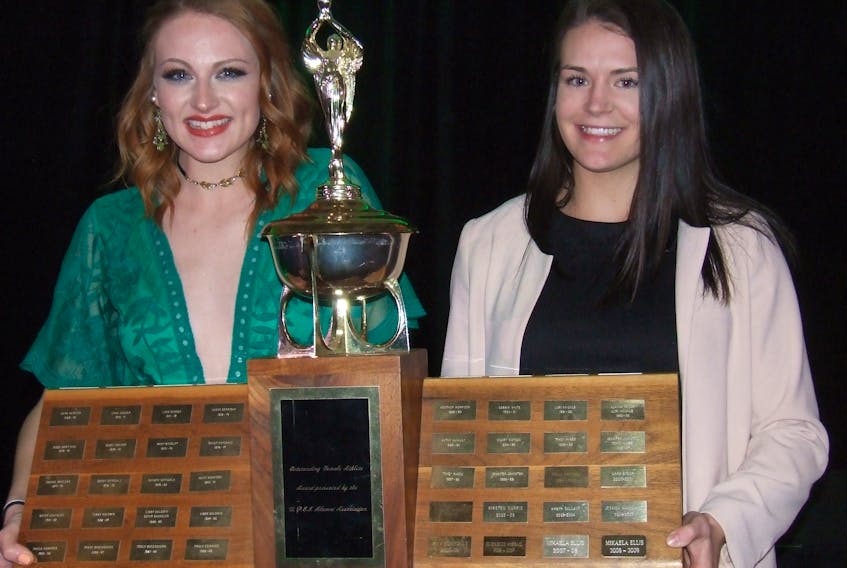 Mount Stewart’s Bailey Smith, left, and Charlottetown’s Alysha Corrigan display their co-female athlete of the year award after winning the trophy Friday at the UPEI Panthers awards ceremony.