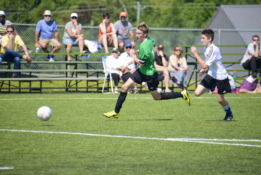 Prince Edward Island’s Liam Wood races for the ball as Nova Scotia’s Caden Facey chases him during the under-14 boys’ bronze medal game at the Atlantic all-star soccer championship Sunday at UPEI.